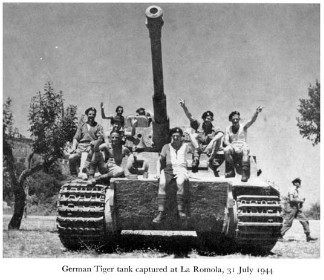Black and white photograph of army officers sitting on a tank