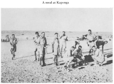 Black and white photograph of soldiers having a meal