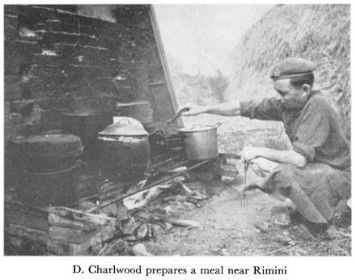Black and white photograph of a soldier cooking
