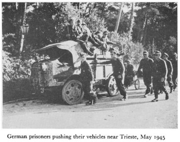 Black and white photograph of soldiers with a vehicle